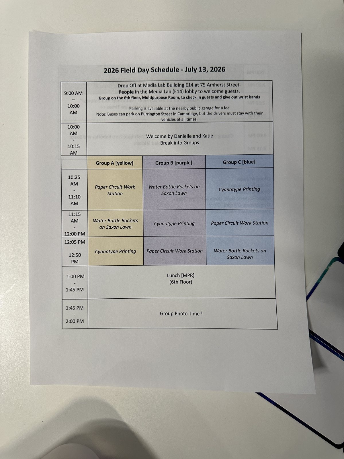 A printed field-day schedule for 13 July 2026, groups rotating through paper circuits, water-bottle rockets and cyanotype printing