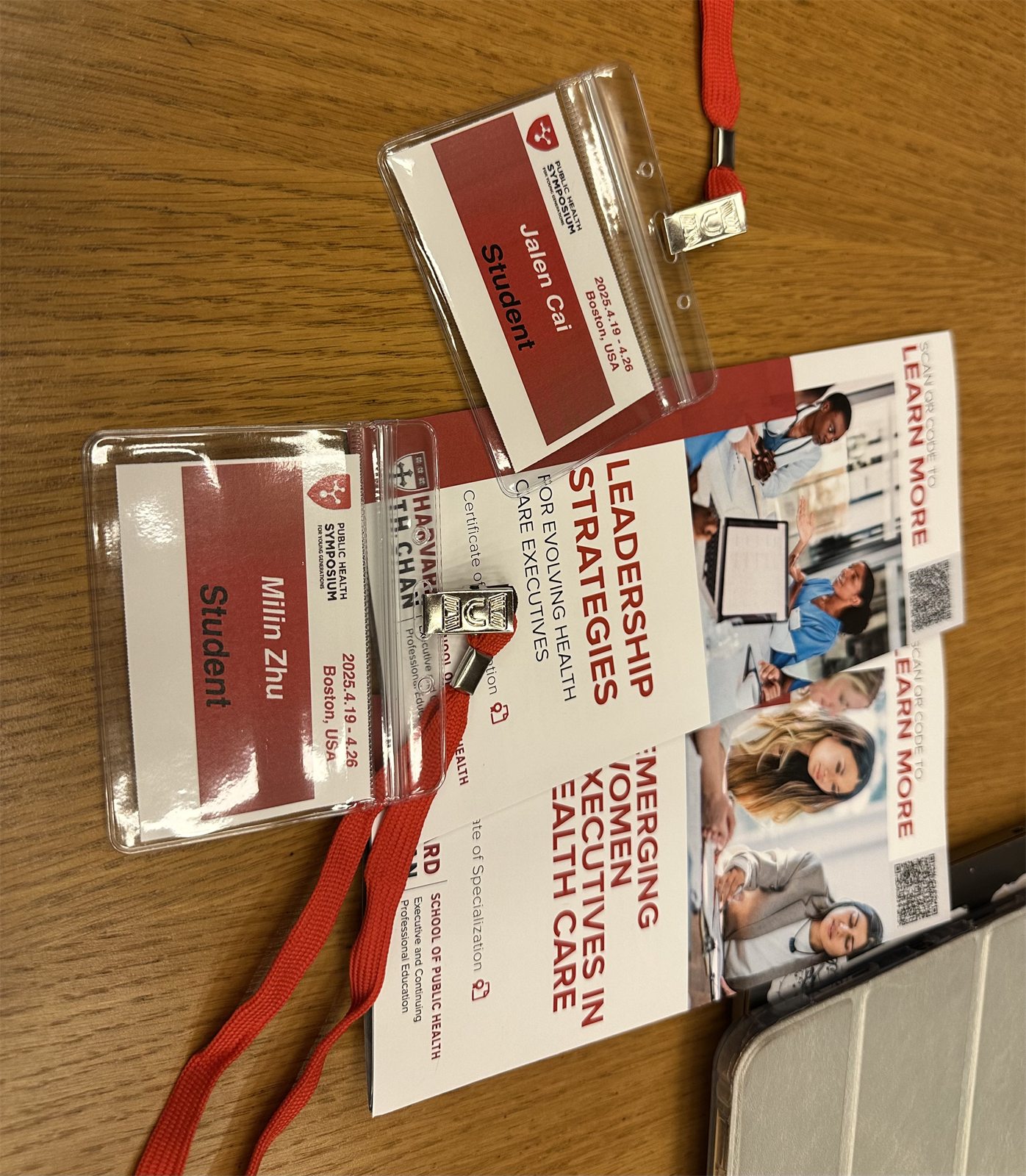 Two student badges for the Public Health Symposium for Young Generations, Boston, one reading Jalen Cai, on Harvard T.H. Chan School of Public Health programme leaflets