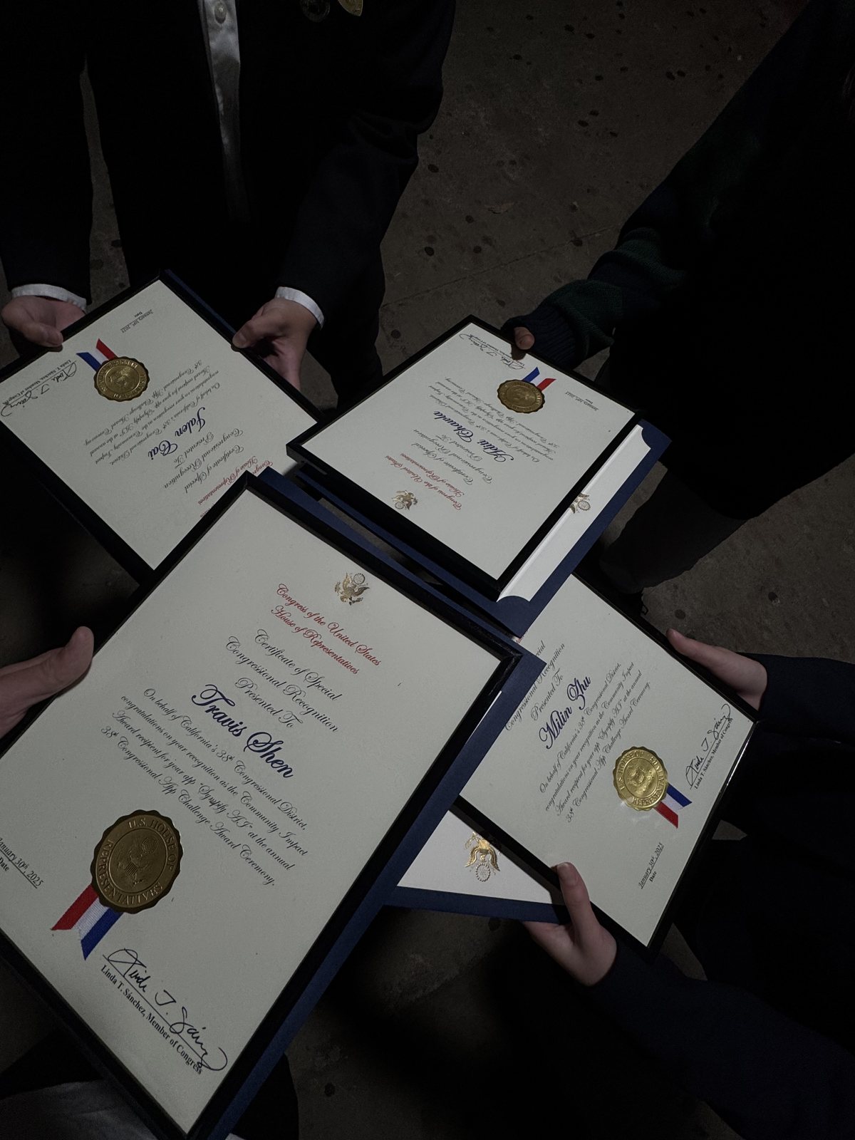 Four framed Certificates of Special Congressional Recognition with gold seals, held up together